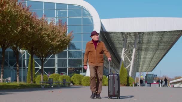 Senior grootvader toerist ga naar de internationale luchthaven terminal voor boarding op het vliegtuig voor reizen — Stockvideo
