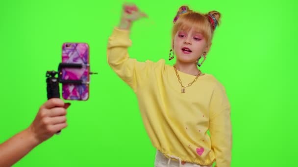 幸せな小さな女の子ブロガーフロントの電話カメラレコードビデオ楽しいですダンスコンテンツ上のクロマキー — ストック動画