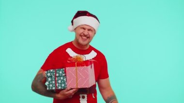 Noel tişörtlü bir adam hediye kutuları ve% 30 indirimli yazılar gösteriyor.