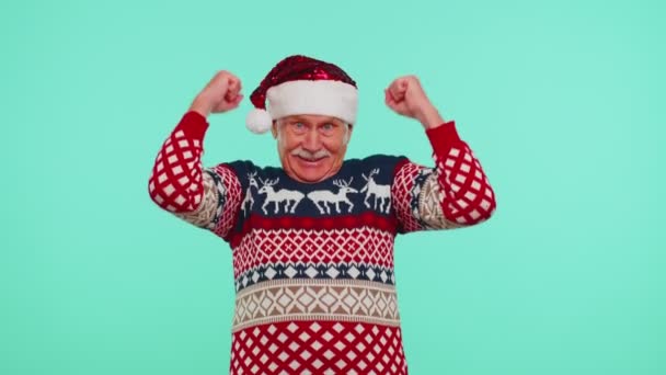 Grootvader in trui Kerstman schreeuwt, viert succes, wint, doelman bereikt — Stockvideo
