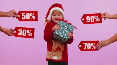 Küçük kız elinde hediye kutuları tutuyor ve Noel indirimleri alıyor. Yazılar, afişler.