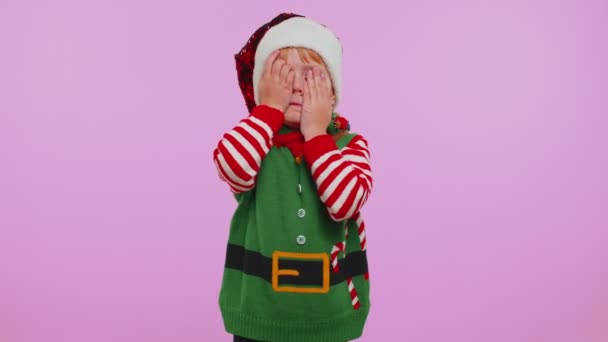 Crazy girl in Santa Christmas costume demonstrating tongue out, fooling around making silly faces — Stock Video