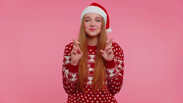 Girl in Christmas Santa sweater praying, looking upward, making wish, asking with hopeful expression — Stock Photo, Image