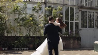 Sevgili yeni evliler, beyaz gelin parkta dans ediyor, öpüşüyor, düğün çifti ailesi.