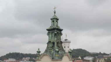 Aerial drone video panorama of Latin Cathedral in city Lviv, Ukraine, flight above roofs, streets