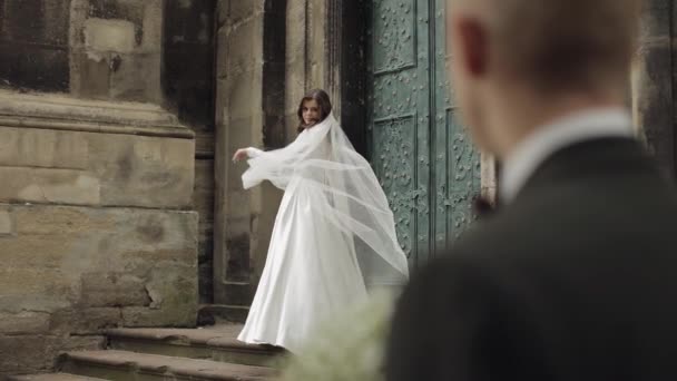 Newlyweds, caucasian groom with bride walking, embracing, hugs on the city street, wedding couple — Stockvideo
