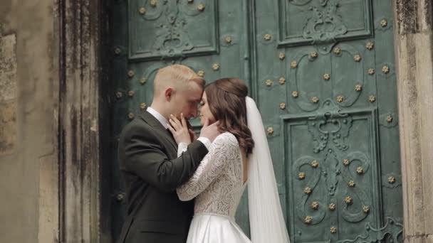 Newlyweds, caucasian groom with bride walking, embracing, hugs in city, wedding couple in love — 图库视频影像