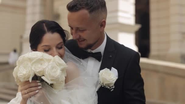 Newlyweds portrait, caucasian groom bride walking, embracing, hugs near old castle, wedding couple — Stock Video