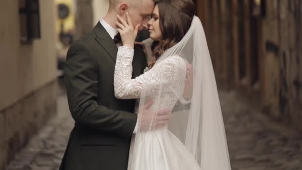 Newlyweds, caucasian groom with bride walking, embracing, hugs in city, wedding couple in love — Video Stock