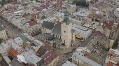 Aerial drone video panorama of Latin Cathedral in city Lviv, Ukraine, flight above roofs, streets