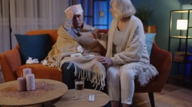 Üst düzey çiftler Coronavirus kilitlemesi sırasında temassız dijital termometreyle sıcaklık ölçer.