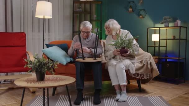 Senior mature old man woman family assembling furniture at home, collect, repair, fixing, teamwork — Stock Video