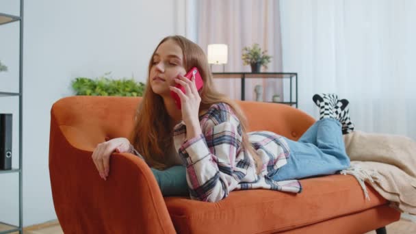Portrait of tired sleepy woman talking on mobile phone with friend making online conversation home — Stock Video