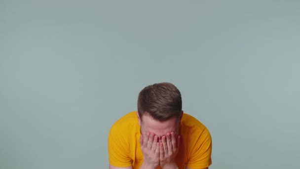 Upset disappointed man alone wipes tears and cries from despair, being sad because of unfair things — Stock Video