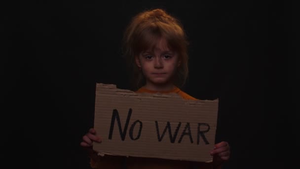 Niña molesta y pobre niña sin hogar protestando por conflicto de guerra levanta pancarta con inscripción No War — Vídeo de stock