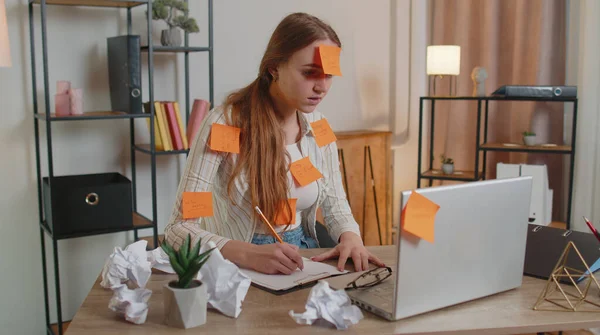 Exhausted woman freelancer with pasted stickers using laptop having concentration problem in office — Stock Photo, Image