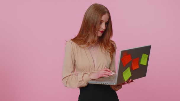 Exhausted woman freelancer with pasted sticker notes using laptop computer, concentration problem — Stock Video