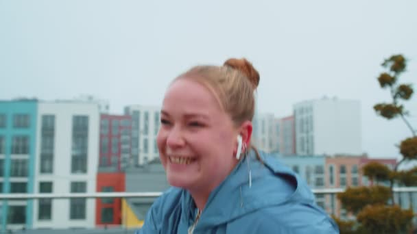 Healthy Caucasian woman exercising workout on stationary cycling machine bike on house rooftop gym — 图库视频影像