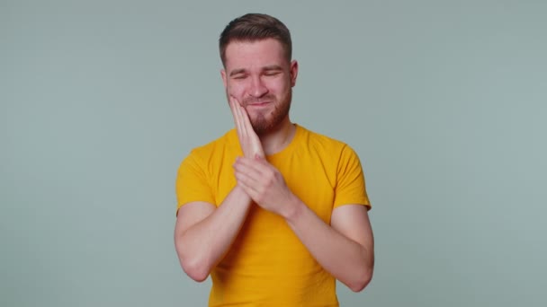 Homme touchant la joue souffrant de caries ou de gingivite en attente d'un rendez-vous chez le dentiste — Video