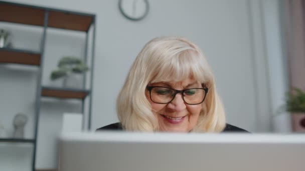 Senior-Geschäftsfrau trägt Brille bei der Arbeit im Home Office, Online-Webinar mit Laptop-Computer — Stockvideo