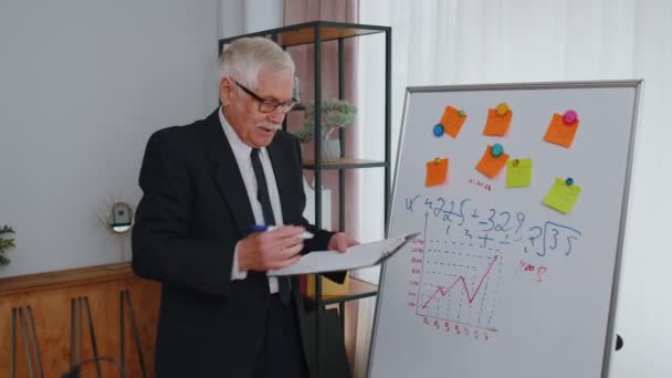 Senior business man coach leider conferentie spreker uit te leggen project strategie op kantoor whiteboard — Stockvideo