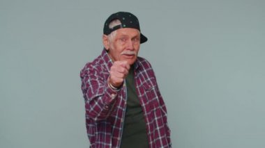 Greedy avaricious senior grandfather man showing fig negative gesture, refusal fig sign, rapacious
