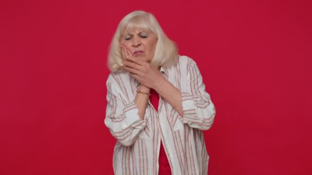 Woman touching cheek suffering from toothache cavities or gingivitis waiting for dentist appointment — Wideo stockowe