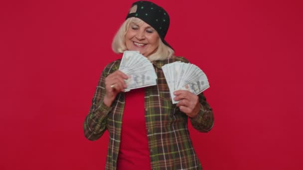 Rich pleased boss senior woman waving money dollar cash banknotes like a fan success business career — Stok video