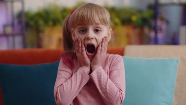 Toddler kid girl winner raising hands in surprise looking at camera, shocked by sudden victory, wow — Stock Video