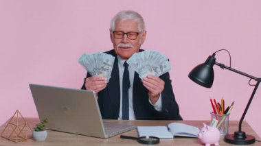 Business office man accountant celebrating business success dancing with stack of money dollar cash