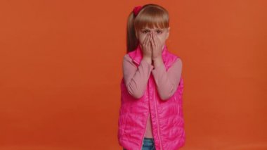 Scared fearful depressed girl kid expresses his fear and waves his hands away from danger, waving no