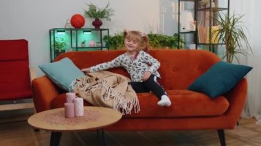 Little tired lazy sleeping children girl lying asleep on sofa feeling lack of energy at home alone