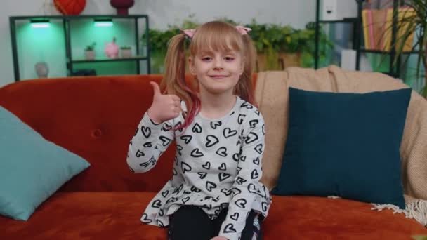 Happy young little girl kid raises thumbs up, good feedback, like approve positive sign gesture — Stock Video