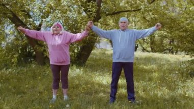 Sporcu fitness son sınıf sporcusu kadın, büyükanne ve büyükbaba sabah parkta kardiyo antrenmanı yapıyor.