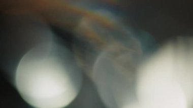 Çok renkli ışık siyah arkaplanda 4K görüntü sızdırıyor. Stüdyoda gaz sızıntısı var. Doğal aydınlatma ışınları bokeh etkisi. Çekimlerinizi birleştirmek, videoyu biçimlendirmek, geçişlerinizi