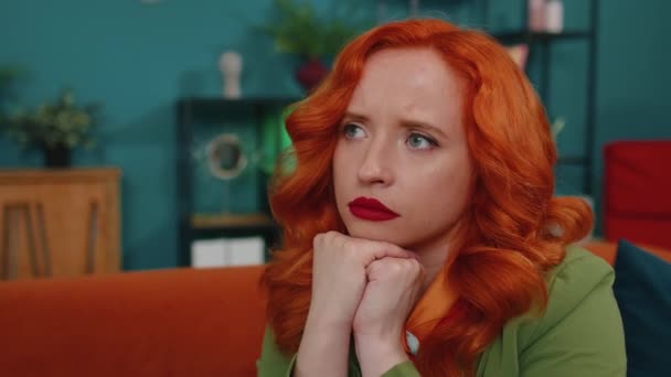 Close Sad Young Redhead Woman Sitting Home Looks Pensive Thinks — Stock Video