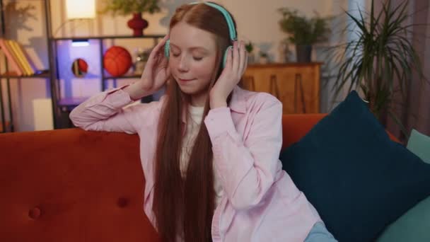 Happy Relaxed Overjoyed Ginger Kid Wireless Headphones Dancing Couch Home — Vídeo de Stock