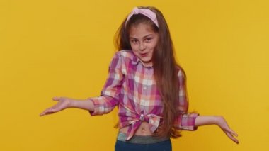 I dont know what to say. Confused preteen child girl kid feeling embarrassed about ambiguous question, having doubts, no idea being clueless and uncertain. Little toddler children on yellow background