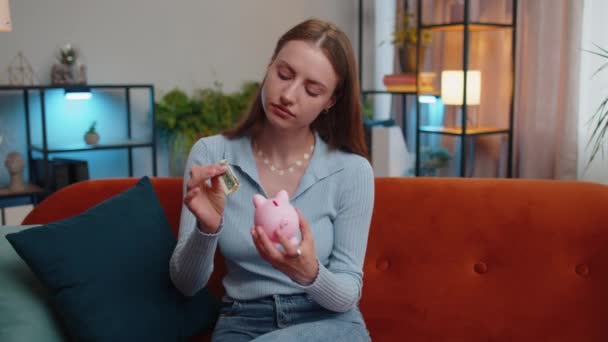 Poor Young Woman Insufficient Amount Money Holding Piggybank One Dollar — Vídeo de Stock