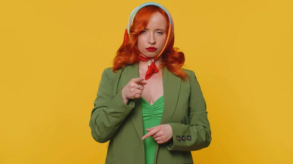 Quarrel. Displeased red hair woman gesturing hands with irritation and displeasure, blaming scolding for failure, asking why this happened. Young ginger girl isolated alone on yellow studio background
