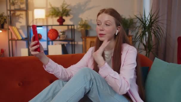 Young Redhead Teenager Child Girl Wearing Earphones Making Phone Online — Vídeos de Stock