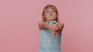Funny amusing preteen child girl kid making playful silly facial expressions grimacing, fooling around, parodies seal animal clapping hands. Little toddler children stupid brainless dumb expression