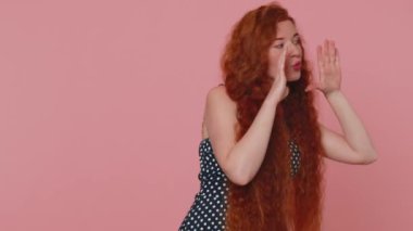 Expressive woman holding hands near mouth loudly screaming, shouting, yelling, announces discounts sale Hurry up, welcomes someone hello. Young redhead girl isolated alone on pink studio background