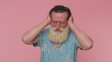 Dont want to hear and listen. Frustrated annoyed irritated senior man covering ears and gesturing no, avoiding advice ignoring unpleasant noise loud voices. Grandfather on pink studio wall background