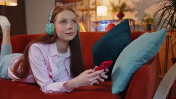 Happy Relaxed Overjoyed Child Girl Wireless Headphones Relaxing Couch Home — Stockvideo