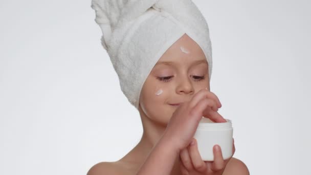 Lovely Young Child Girl Towel Head Applying Cleansing Moisturizing Cream — Stock videók