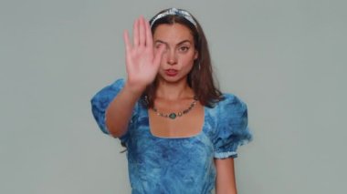 Stop. Young woman say No hold palm folded crossed hands in stop gesture, warning of finish, prohibited access, declining communication, body language, danger. Adult girl isolated on gray background