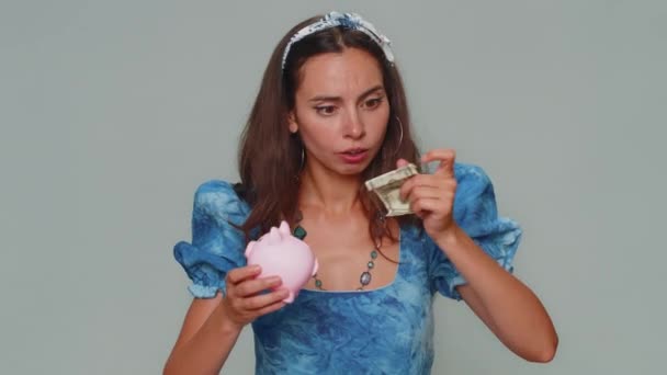 Poor Pretty Young Woman Insufficient Amount Money Holding Piggybank One — Stockvideo