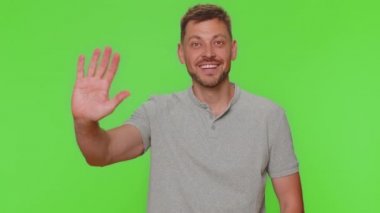 Come here, join us. Welcome. Bearded handsome man showing inviting gesture with hands, ask to join, beckoning to coming, gesturing hello or goodbye. Adult stylish guy isolated on chroma key background