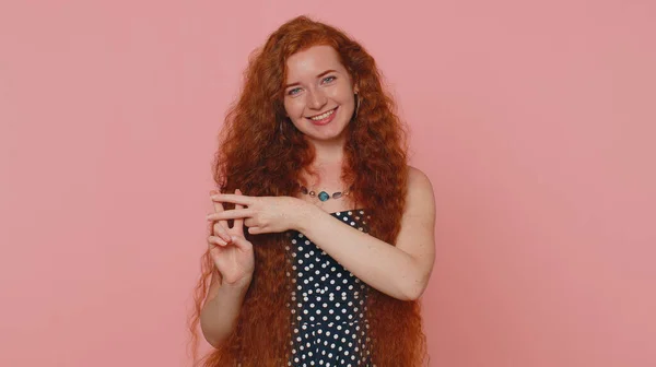 Hashtag. Cheerful redhead young woman showing hashtag symbol with hands, likes tagged message, popular viral content, sign to follow internet online trends. Ginger girl isolated on pink background
